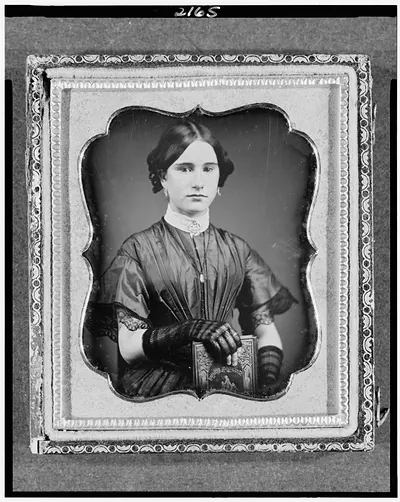 Daguerreotype of a seated woman holding a book