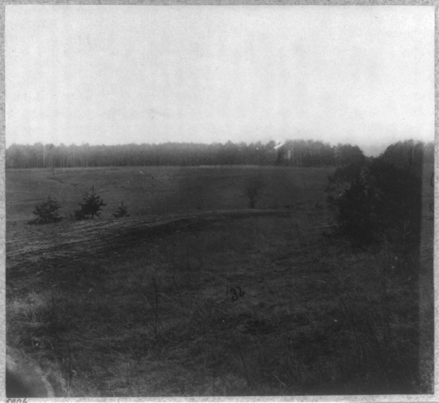 Battlefield of the Wilderness". Palmer's field on Orange Turnpike - Confederate entrenchments at edge of woods", [no date recorded on caption card] — historic photograph