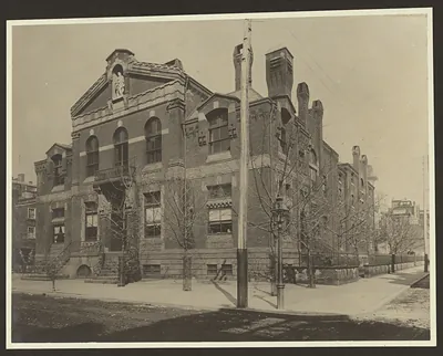 Brick corner building with arched windows and sculpted niche