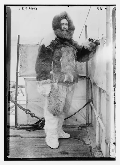R.E. Peary, on deck of "Roosevelt" in fur parka, with binoculars