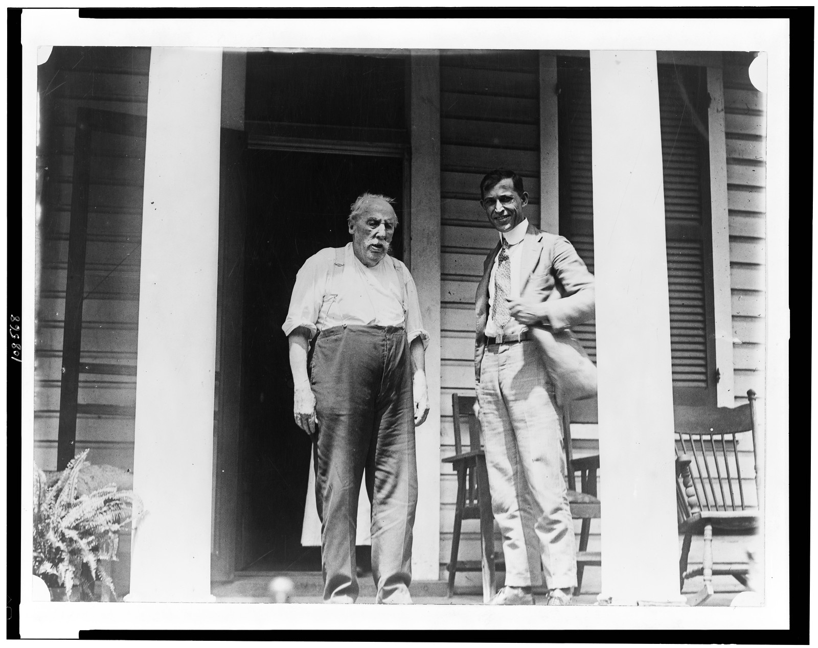[L.D. Anderson, of Anacostia, 95 years old, oldest member of Metropolitan Police, full-length, standing on porch, with another man, facing slightly right], [between 1909 and 1932] — historic photograph