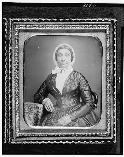[Jerusha Field, half-length portrait, seated in chair, with arm resting on table with tablecloth]