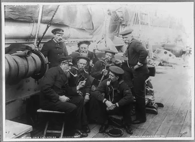 U.S.S. ENTERPRISE: spinning a yard [group of older crew men on deck]