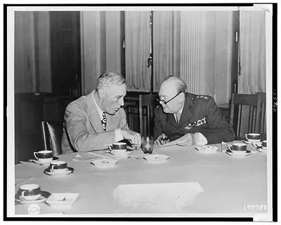 A Crimean huddle--Mr. Roosevelt shows strain of overwork as he huddles with Mr. Churchill at Yalta / Signal Corps U.S. Army.