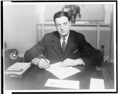 [Rep. Alvin E. O'Konski, half-length portrait, seated at desk, facing front, holding fountain pen]