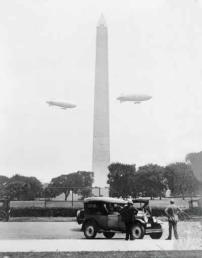 U.S. Army blimps, the T.C. 5 and T.C. 9 from Langley Field, Va. passing over the Washington Monument during a practice flight