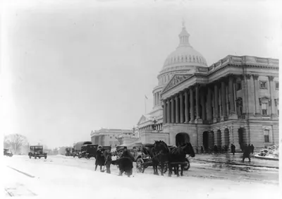 [Men, with horses and wagon, shoveling snow from driveway in front of U.S. Capitol]