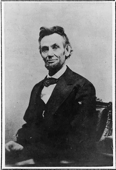 Seated man in dark suit and bow tie, black and white portrait photograph