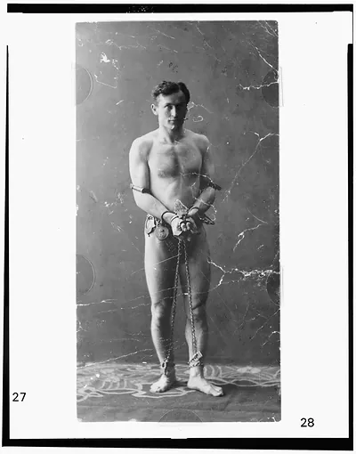[Harry Houdini, full-length portrait, standing, facing front, in chains]