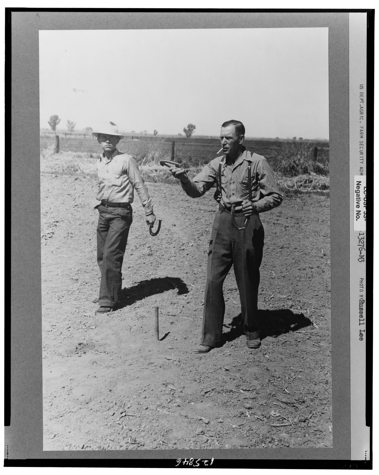 Horseshoe pitching contest at the annual field day of the FSA (Farm Security Administration) farmworkers community, Yuma, Arizona, 1942 Mar. — historic photograph