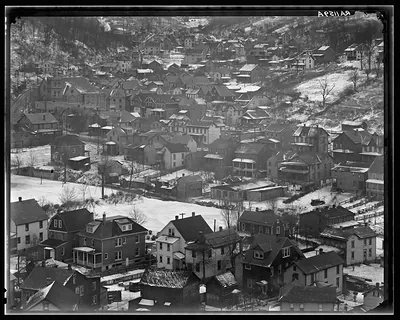 Aerial view of hillside houses in a snowy town