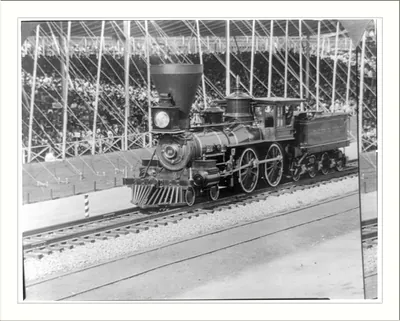 Steam locomotive on tracks in an exhibition hall