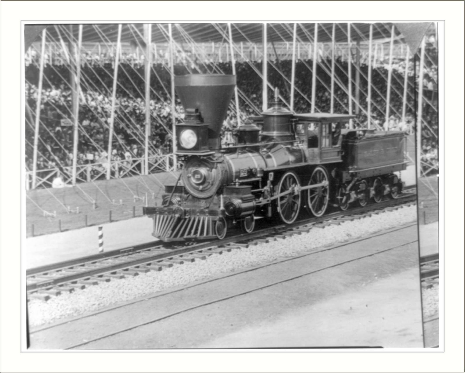 Steam locomotive on tracks in an exhibition hall — historic image