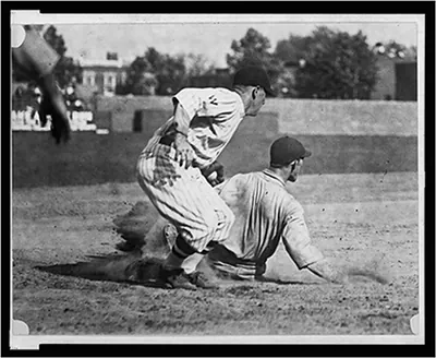 [Washington fielder applies tag to ball player sliding into base]