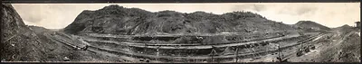 Panoramic photograph of Panama Canal excavation cut with railway tracks