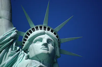 Statue of Liberty face and crown against blue sky