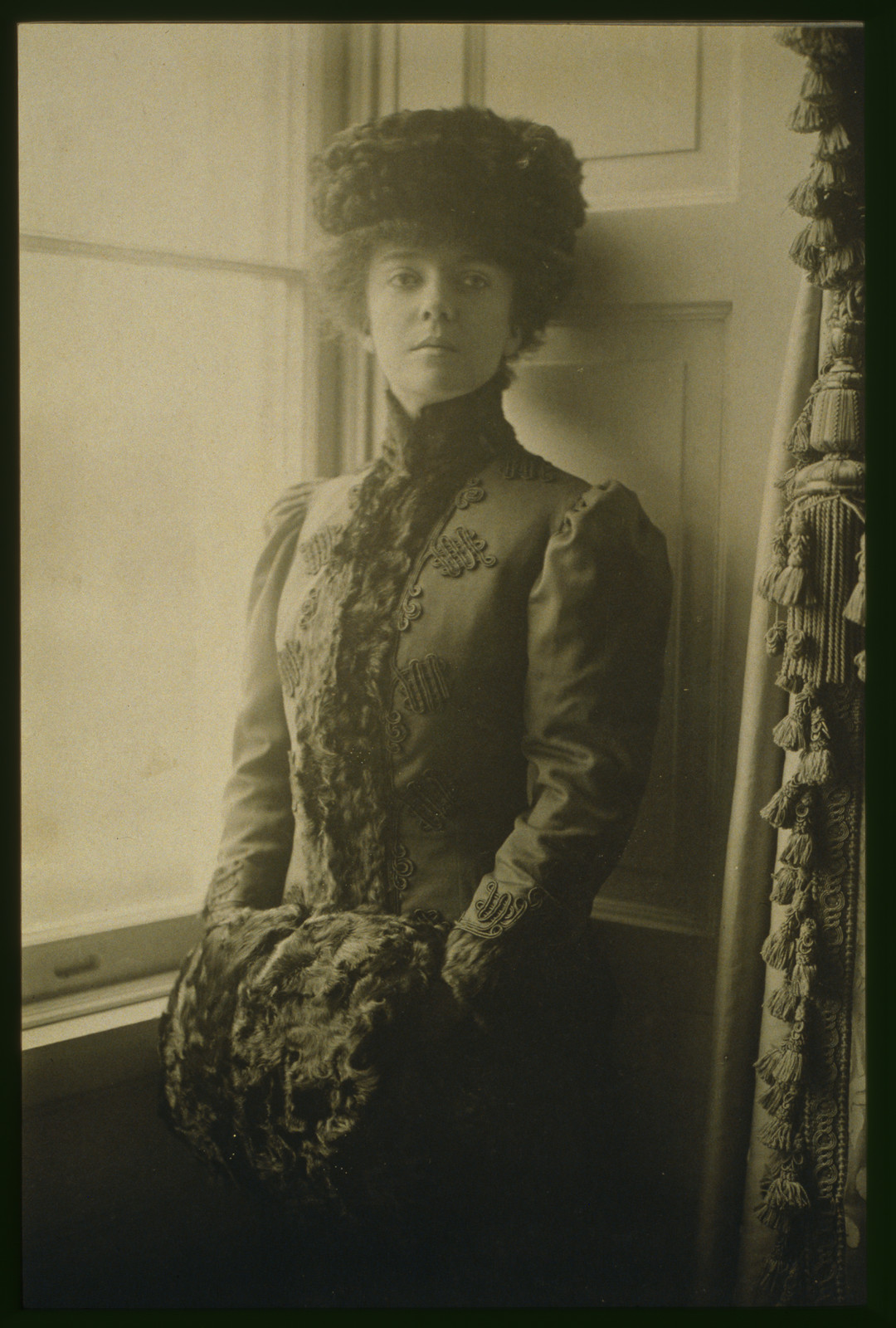 [Alice Roosevelt Longworth, three-quarter length portrait, wearing hat and muff, standing at window, facing front], c1906 Feb. 8. — historic image