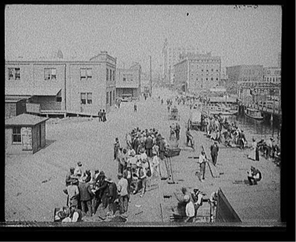 [Lunch hour on the levee, Jacksonville, Fla.], [between 1900 and 1915] — historic photograph