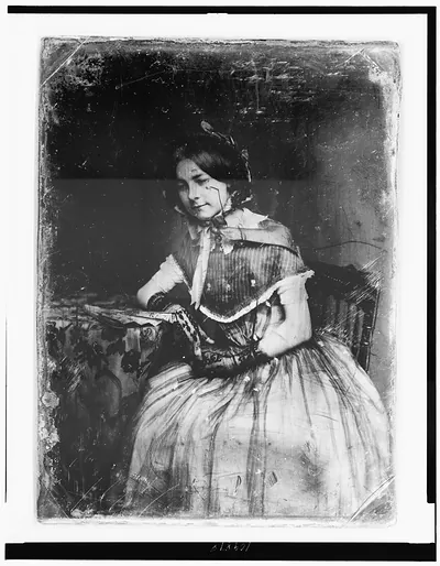 Seated woman in striped dress, early photographic portrait