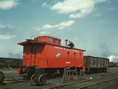 Chicago & North Western red caboose with workman on roof