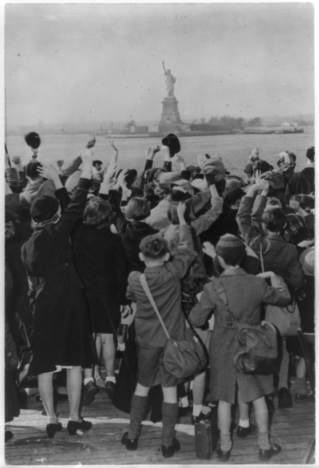 [The Statue of Liberty: British children sent to the U.S. for the war's duration hailing the statue as their ship enters New York Harbor], [1944?] — historic photograph
