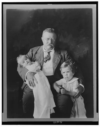 [Theodore Roosevelt, three-quarter length portrait, seated, facing slightly right, with Master Richard Derby, and holding Kermit Roosevelt, Jr.]