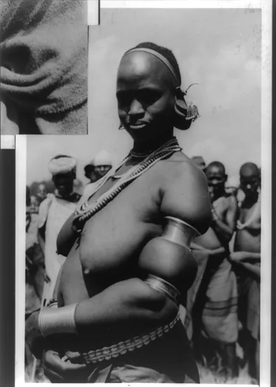 [Bare-breasted native woman with circular ornaments on arm forming a peculiar upper arm, Kenya]