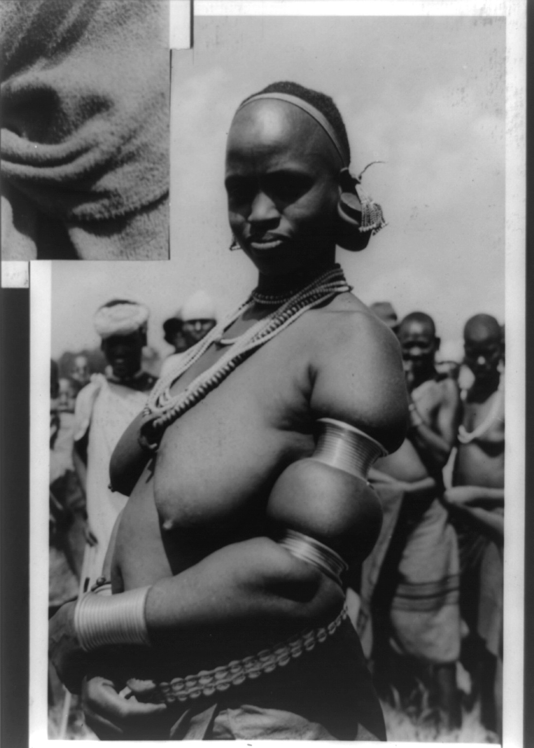[Bare-breasted native woman with circular ornaments on arm forming a peculiar upper arm, Kenya], [between 1940 and 1948] — historic photograph