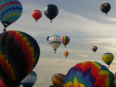 Hot air balloons rising in the sky at a festival