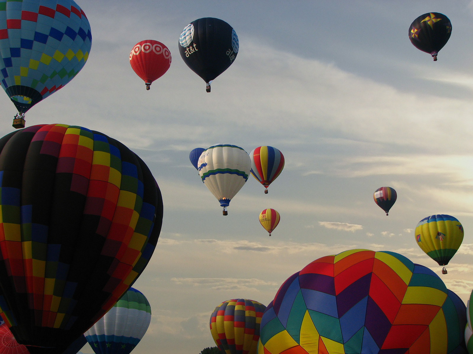 Hot air balloons rising in the sky at a festival — historic image