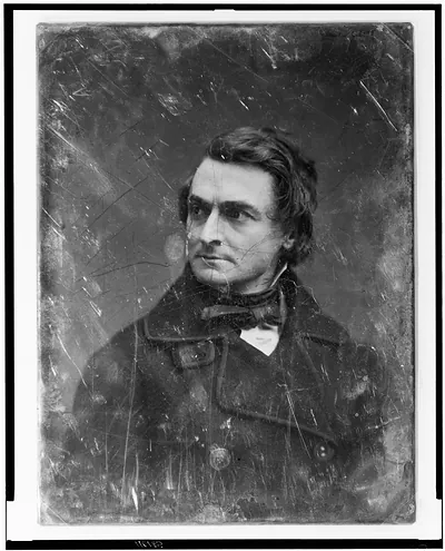 Portrait of a man in a dark coat and bow tie