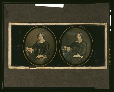 [Mrs. William Y. McAllister, half-length, seated, with arm resting on table with tablecloth]