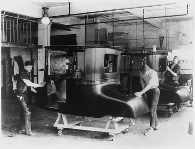 [Fisher Body Co. original plant number one, Detroit, 191-. Men putting a bright finish on auto body by rubbing it with felt and pulverized pumice stone]