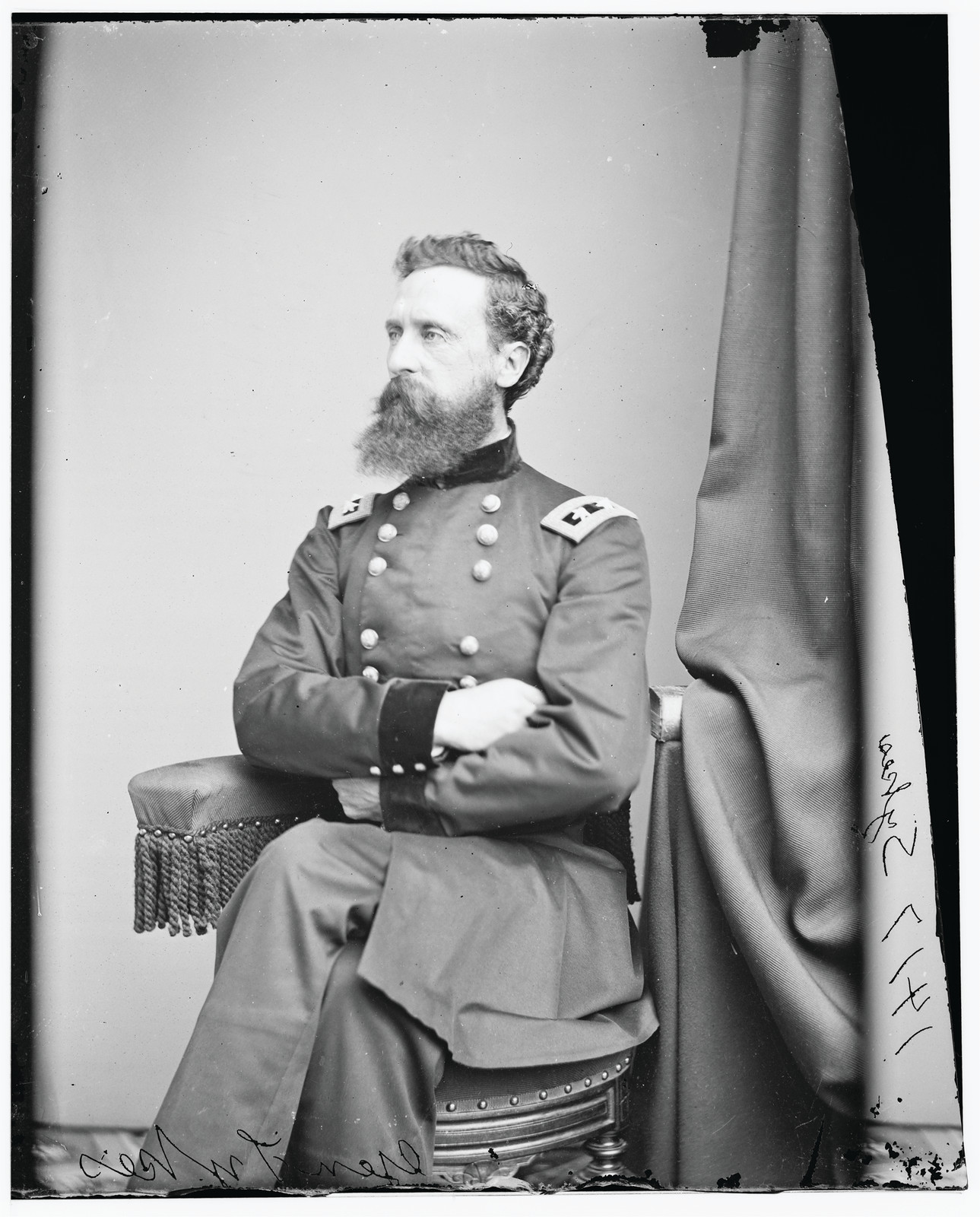 Seated bearded Union officer in studio portrait photograph — historic photograph