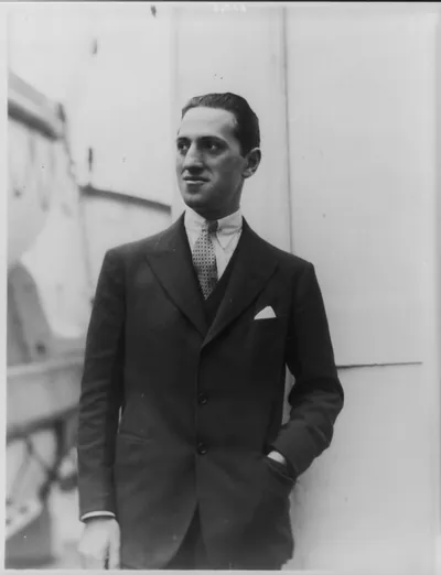 [George Gershwin, 1898-1937, half-length portrait, standing, facing left]