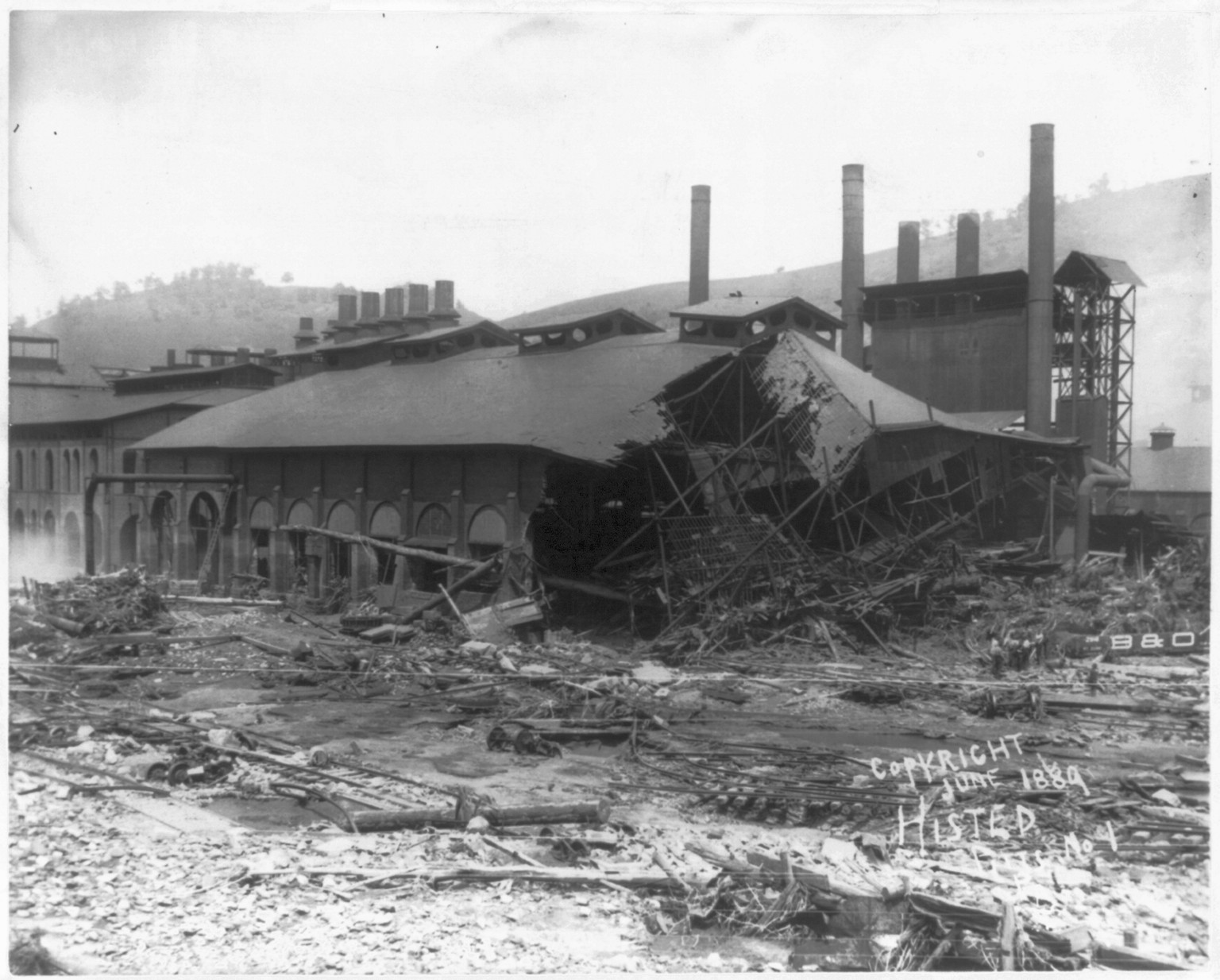Ruins of Cambria Iron Mills from stone bridge P.R.R., Johnstown Flood, May 31st, 1889, c1889. — historic photograph