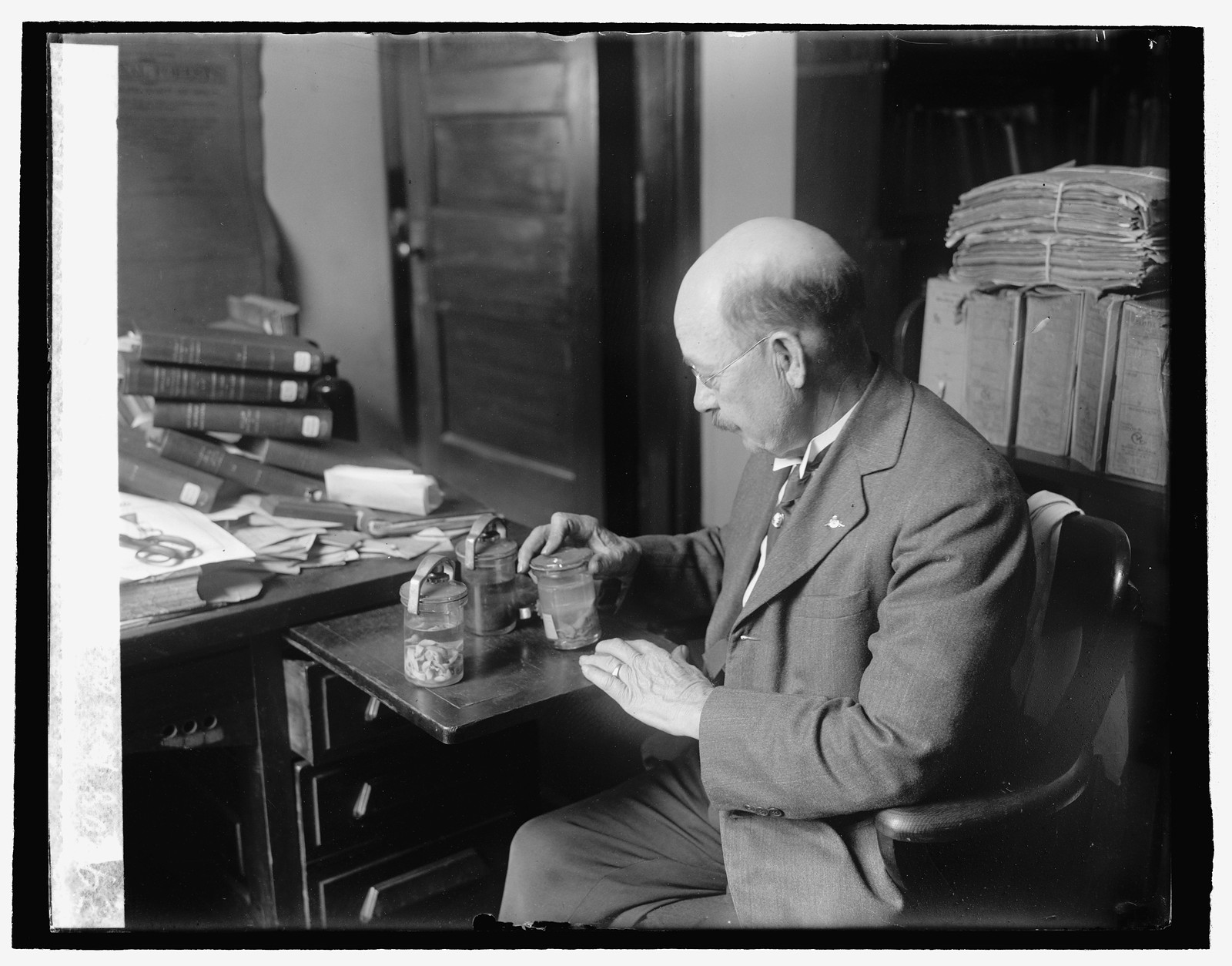 Dr. Albert Hassall of Ag. Dept with animal parasites, 4/17/26, [19]26 April 17. — historic photograph