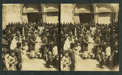 Crowd with palm branches before a stone church doorway