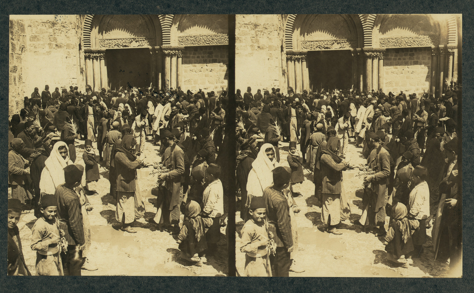 Crowd with palm branches before a stone church doorway — historic image