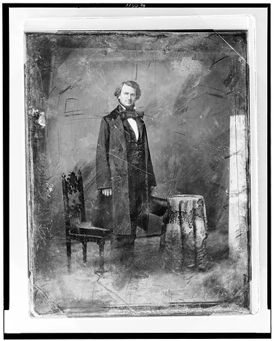 [Taliaferro Preston Shaffner, full-length portrait, three-quarters to the right, head front, standing, holding a tall hat. On the left is a chair and on the right a small table covered with tablecloth]