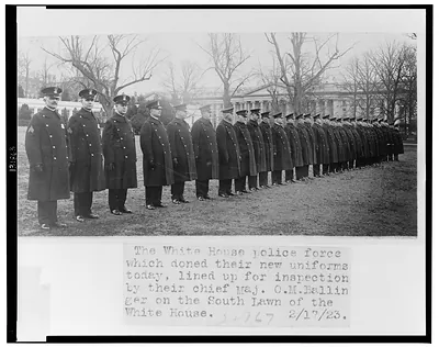 The White House police force which doned [sic] their new uniforms today, lined up for inspection by their chief Maj. O.M. Ballinger on the south lawn of the White House