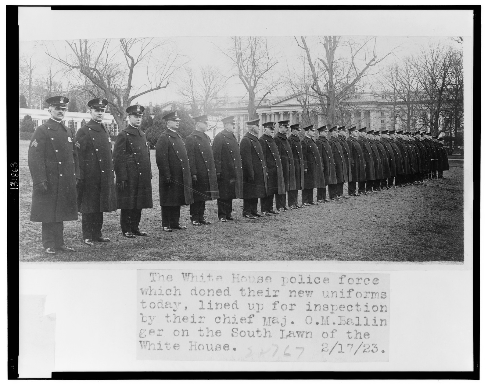 The White House police force which doned [sic] their new uniforms today, lined up for inspection by their chief Maj. O.M. Ballinger on the south lawn of the White House, 1923 Feb. 17. — historic photograph
