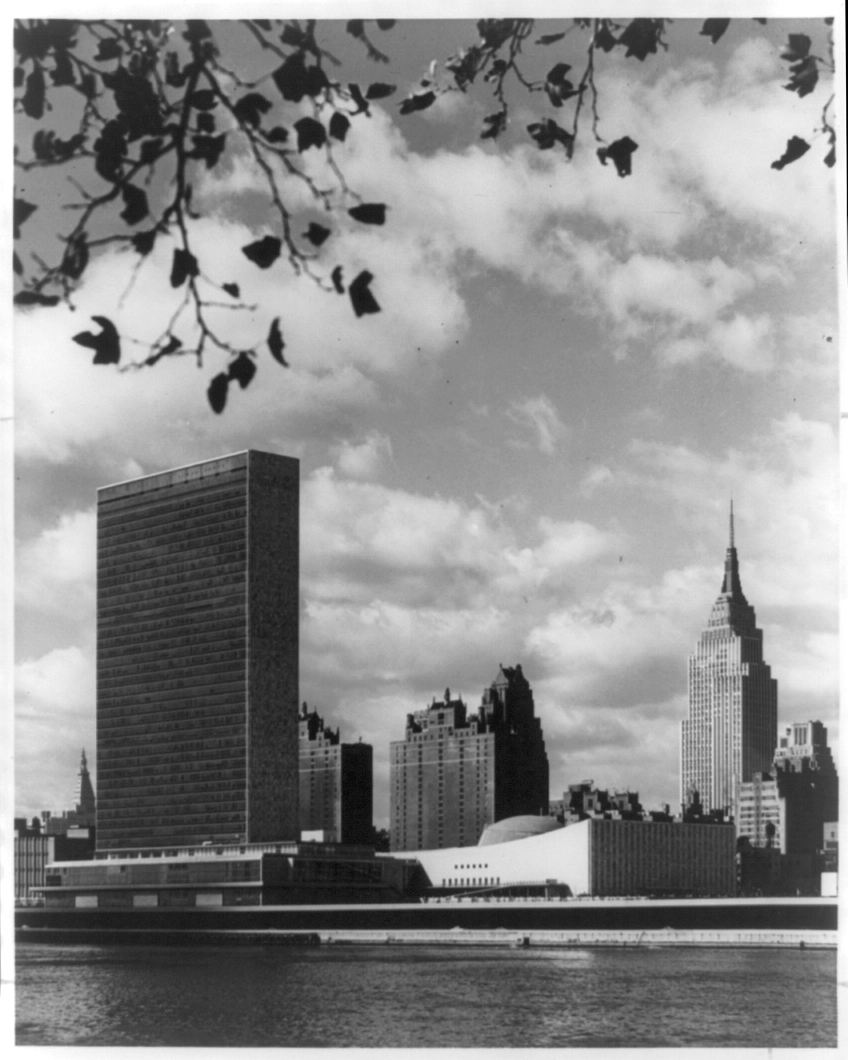 The Headquarters of the United Nations and New York's mid-Manhattan skyline, as seen from the southern tip of Welfare Island, in the middle of the East River.... The U.N. gardens are at right, 1955 — historic photograph