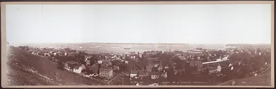Panoramic photograph of a town overlooking a harbor