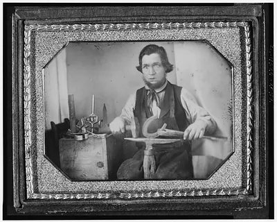 Blacksmith with horseshoe and anvil, daguerreotype portrait