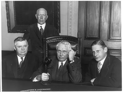 [J. Reuben Clark, Secretary of State Kellogg talking (on telephone with Austrian Chancellor), Edgar L.G. Prochnik and C.T. Claggett, at formal opening of the Trans-Atlantic Telephone Service between their Nations at the State Department in Washingotn]