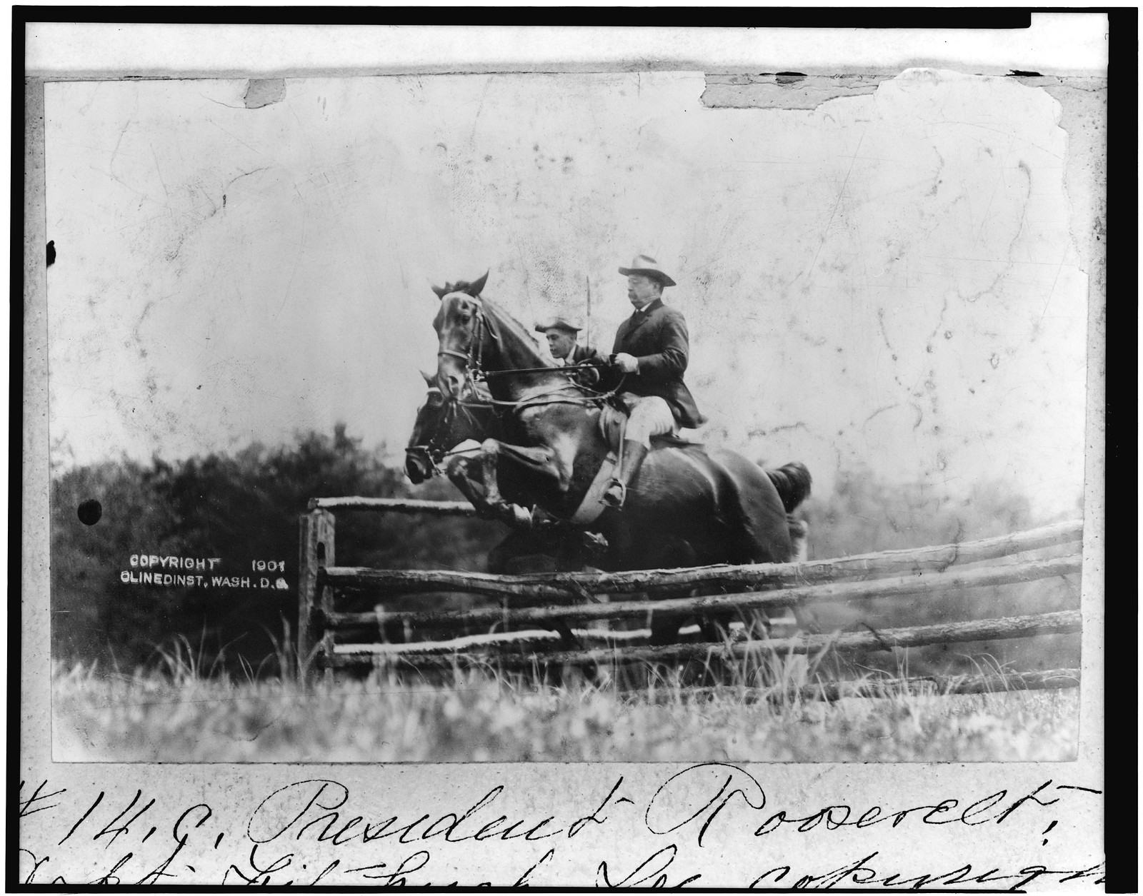 [President Theodore Roosevelt and Capt. Fitzhugh, on horseback, jumping fence], c1907. — historic photograph