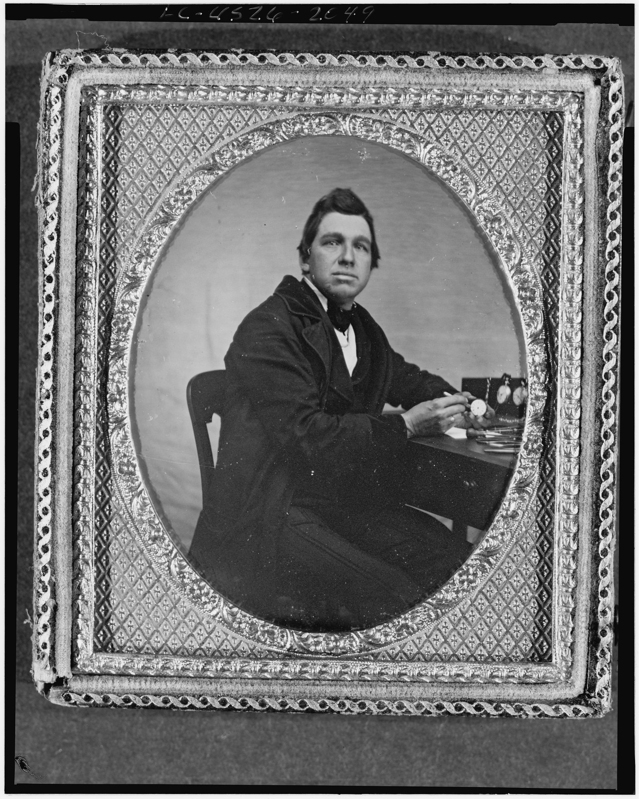 Daguerreotype portrait of a seated man with pocket watches, 1840 — historic photograph