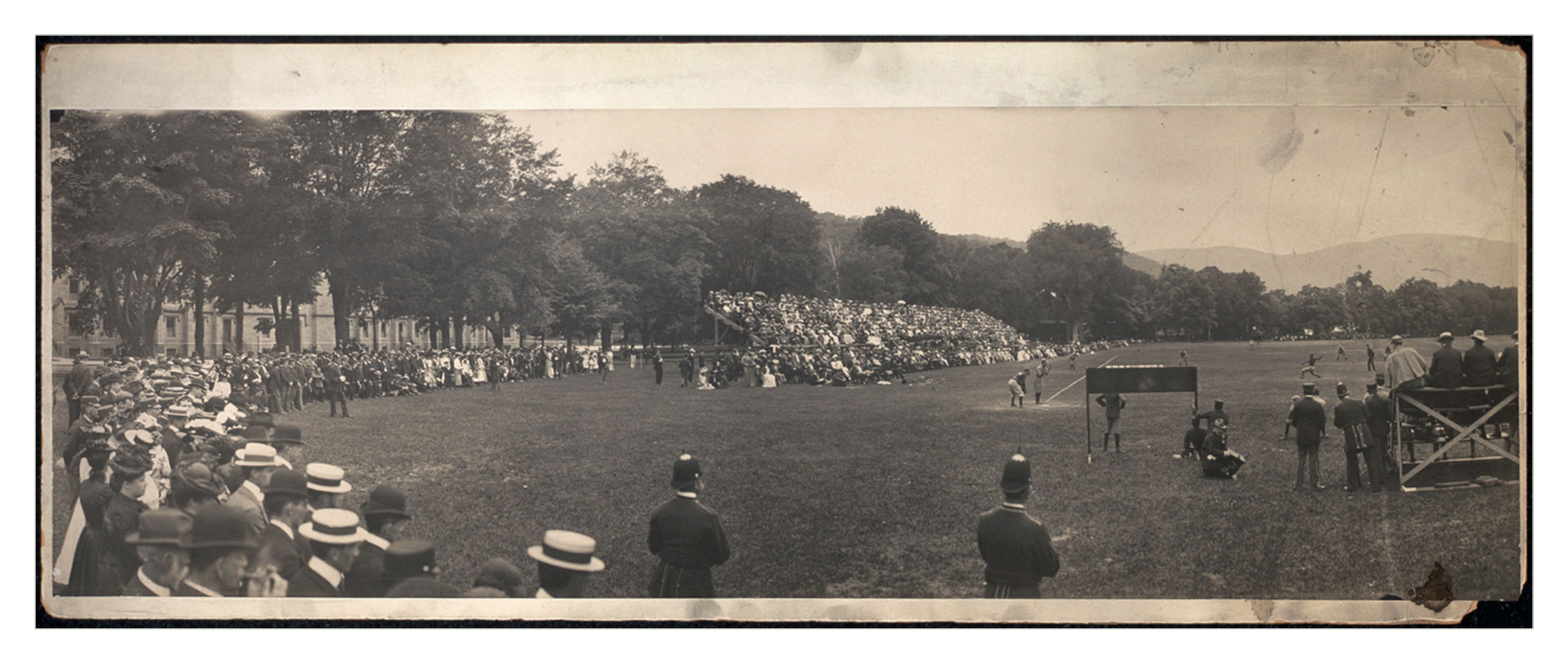 Panoramic photograph of a crowd watching an outdoor field event — historic photograph