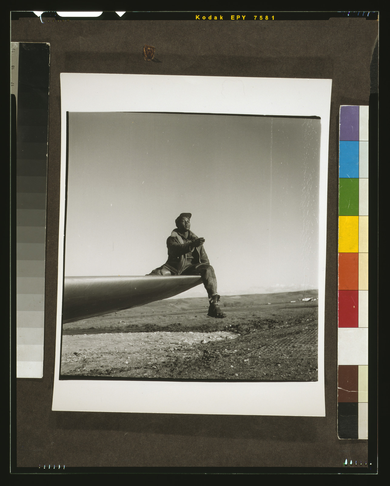 [Black fighter pilot series: Ground crewman of the Red-Tailed Mustangs, 332nd Fighter Pilot Squadron, sitting on wing to direct pilot, Ramitelli, Italy], [1945 March] — historic photograph